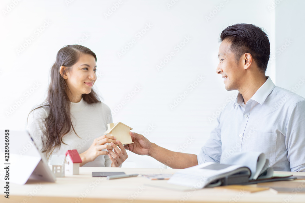 Happy couple plan buying house.Concept for Couple saving money for buy home and real estate. Select material for decorate furniture. Happy couple plan buying house.Concept for Couple saving money for buy home and real estate. Select material for decorate furniture.