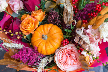 Autumn halloween bouquet, composition with pumpkin close up. Flowers background
