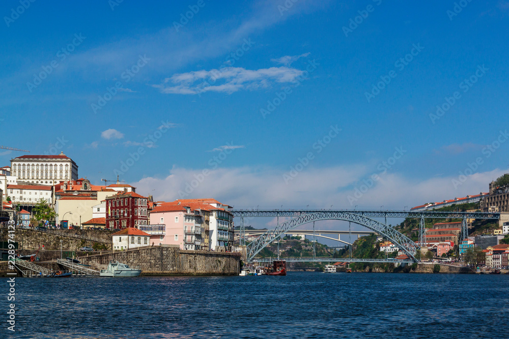 City view from the river Douro. Porto, Portugal. Dom Luís I Bridge.