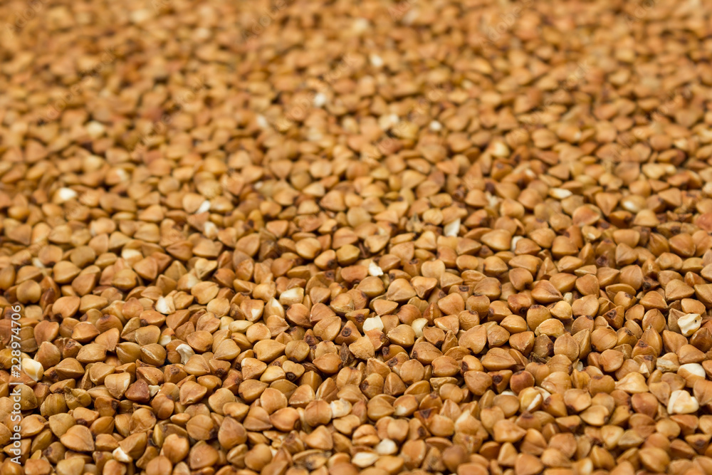 Dry buckwheat grains - brown texture Dry buckwheat grains - brown texture
