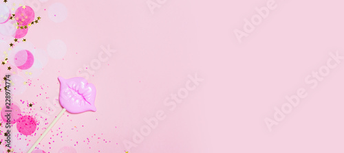 Creative confetti background vith pink lips. Top view photo