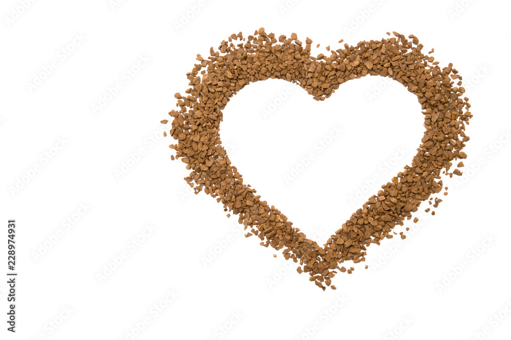 Dry instant coffee granules in the shape of a heart - brown texture Dry instant coffee granules in the shape of a heart - brown texture