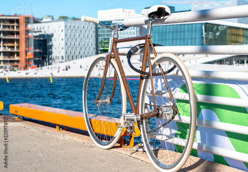 Beautiful, retro style bicycle parked on the street. White wheels, White Bicycle saddle, vintage style. Oslo, Norway