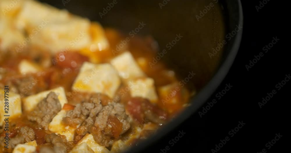 Asian chef cooking Chinese style Sichuan mapo tofu food in a hot pan Asian chef cooking Chinese style Sichuan mapo tofu food in a hot pan