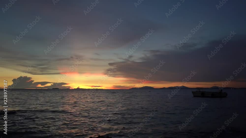 Timelapse Sunset light like a heart shape in the sky falling from the rim of horizontal sea to the dark screen. Timelapse Sunset light like a heart shape in the sky falling from the rim of horizontal sea to the dark screen.
