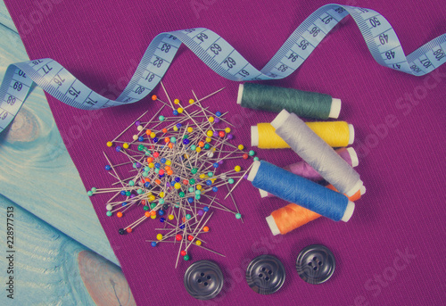 Supplies and accessories for sewing - scissors, threads, pins, buttons, centimeter.