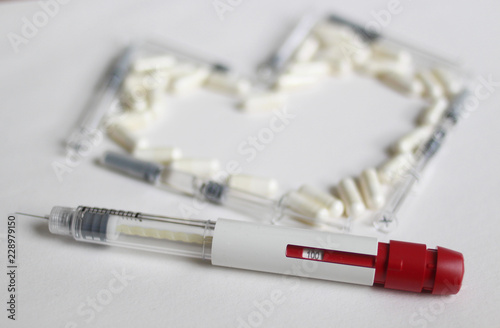 In Vitro Fertilization injection pen. IVF treatment drugs, syringes, needles and pills. Stims and pio shots. Medication for infertility treatment on white background.  