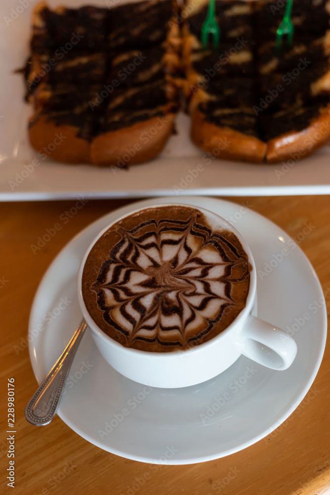 Coffee in a cup and bread with chocolate
Coffee in a cup and bread with chocolate