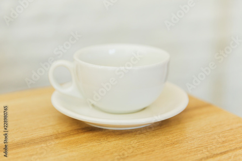 white empty cup on wooden table in a restaurant