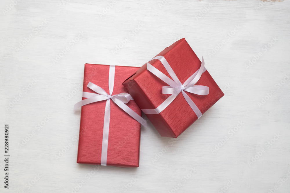 Two Red gift box with white ribbon isolated on white background. Two Red gift box with white ribbon isolated on white background.