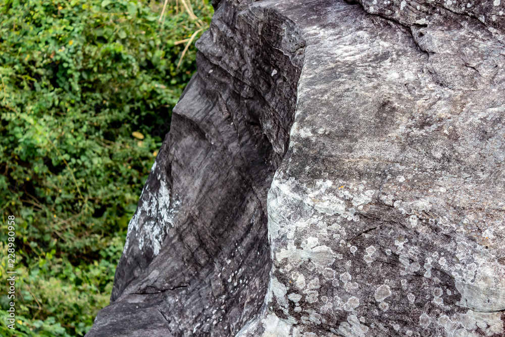 Looking off the mountains edge at Phu Foi Lom, Udon Thani Thailand, at a wall of rock eroded by water and wind of time.