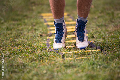 american football player exercises on ladder drills