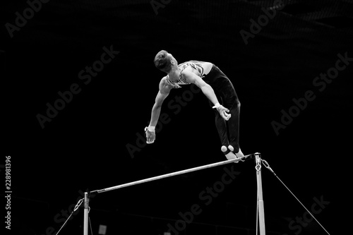 exercise on horizontal bars athlete gymnast black and white photo