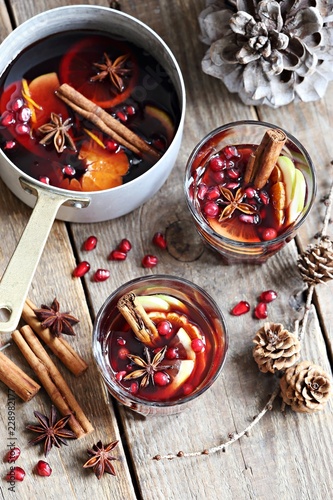 Mulled wine,punch,bowle oder spiced tea : winter traditional warming drinks with spicy,citrus fruits and pomegranate . Rustic style.
