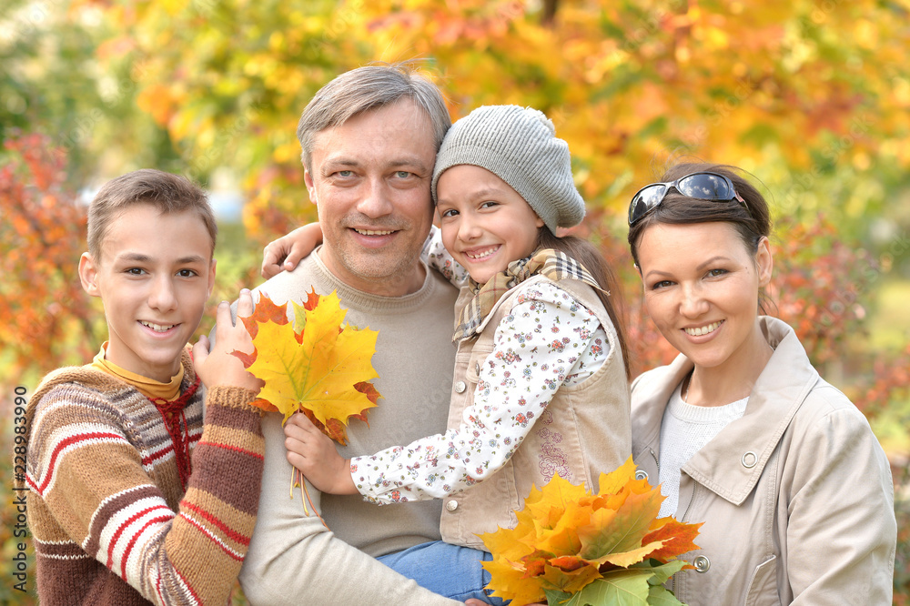 Portrait of happy family in autumn park Portrait of happy family in autumn park