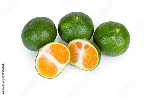 Fototapeta Naklejka Na Ścianę i Meble -  Whole ripe green tangerines and one tangerine cut in half