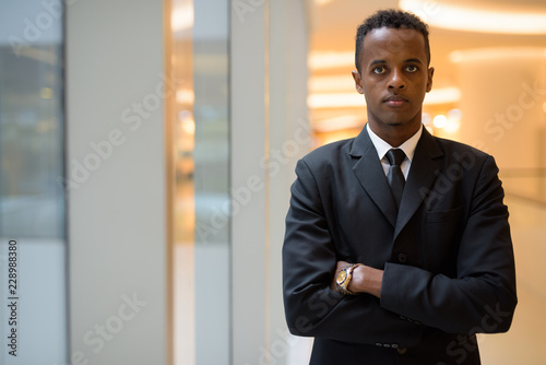 Portrait of young African businessman with arms crossed
