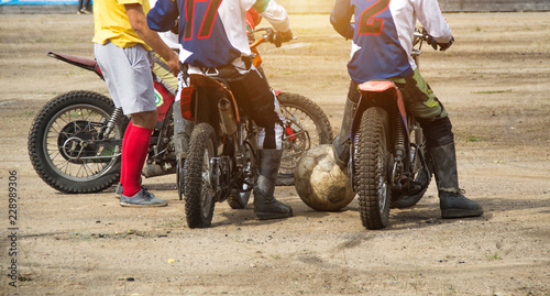 Competitions on motoball, players are furiously fighting for the ball, playing football on motorcycles, motor bicycle photo