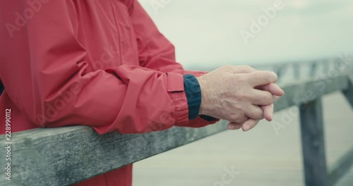 Senior woman resting on pier photo