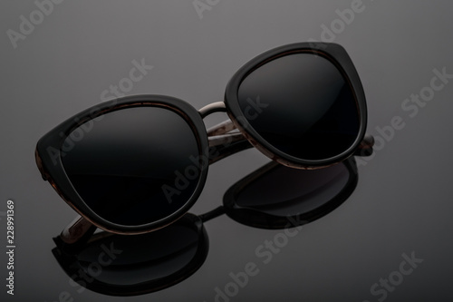 sunglasses on a dark background with reflection