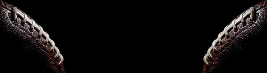 American football on a black background. panorama or with blank space