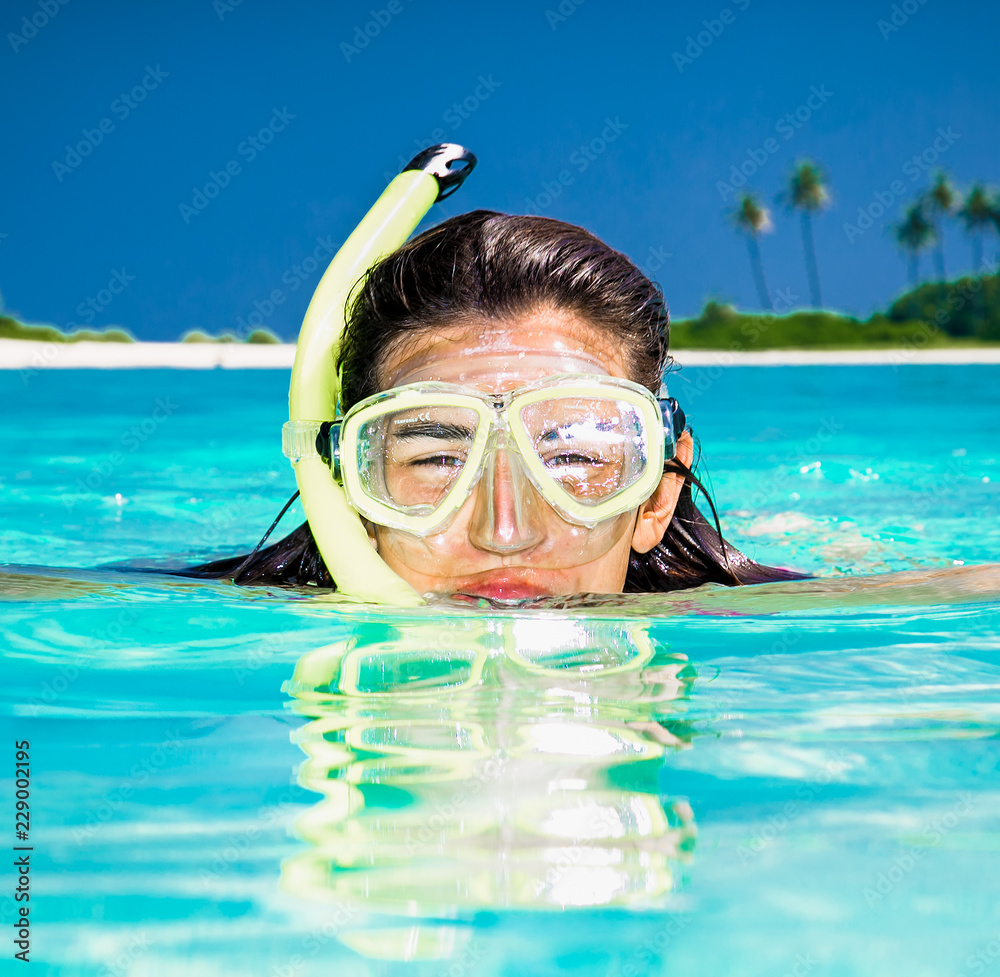 Naklejka premium Happy girl at topical beach on Olhuveli island. Maldives.