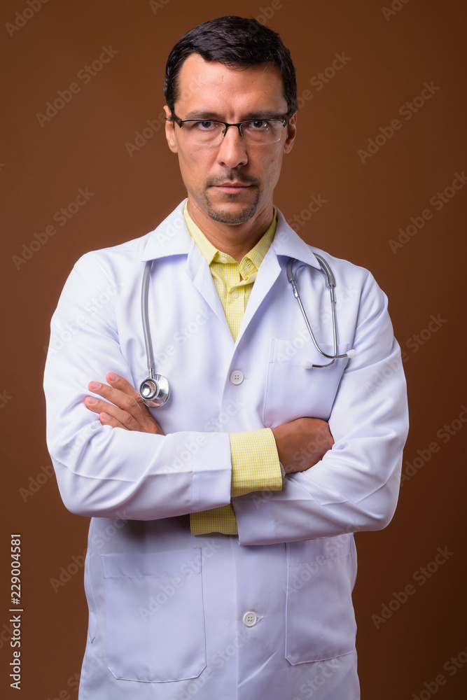 Portrait of handsome man doctor with arms crossed Portrait of handsome man doctor with arms crossed
