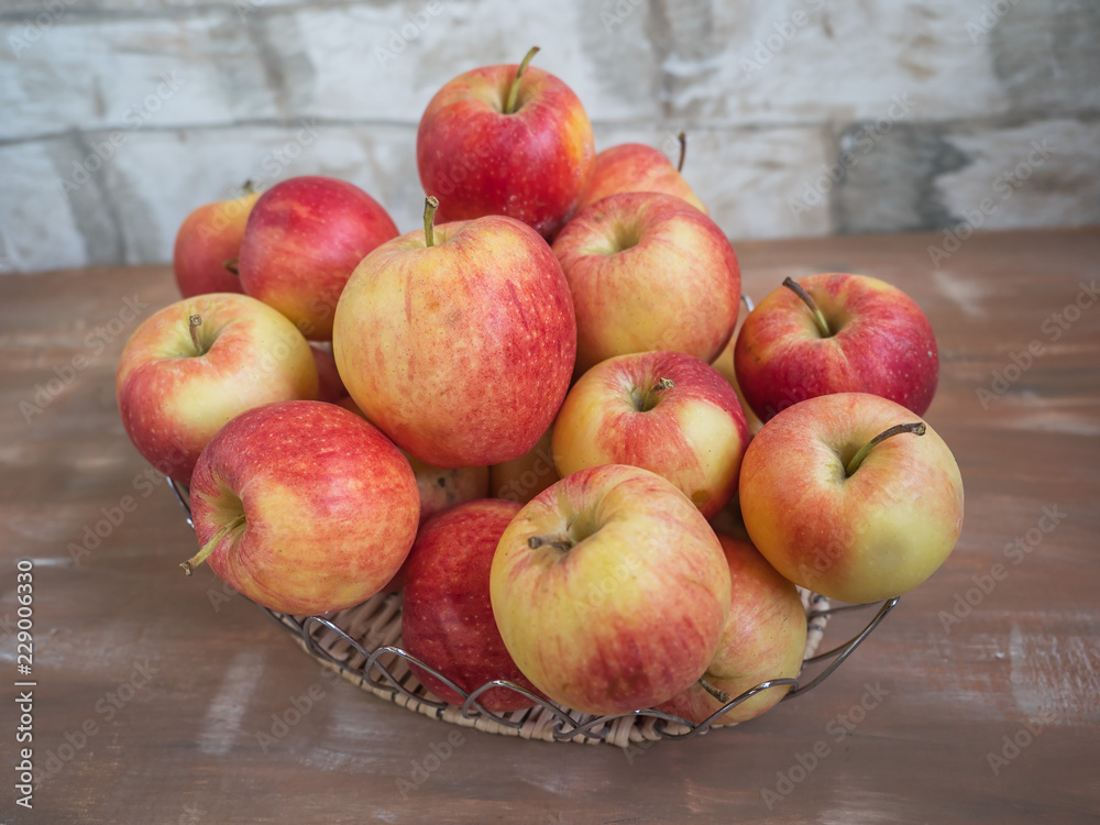 Metal basket with Big harvest ripe apples close-up Metal basket with Big harvest ripe apples close-up