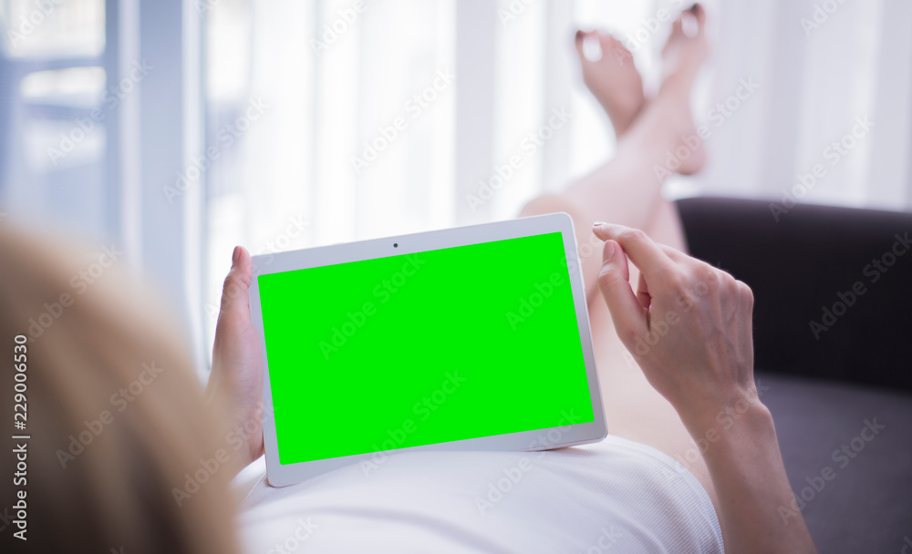 woman is relaxing and using tablet woman is relaxing and using tablet