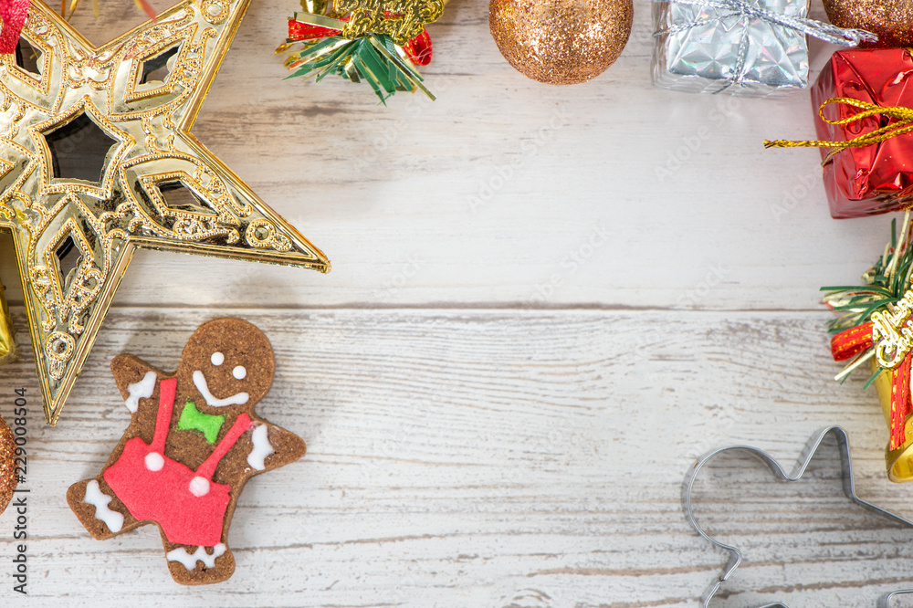Beautiful Christmas composition and decoration with baked gingerbread man cookie on light wooden background, flat lay, top view, copy space (text space)