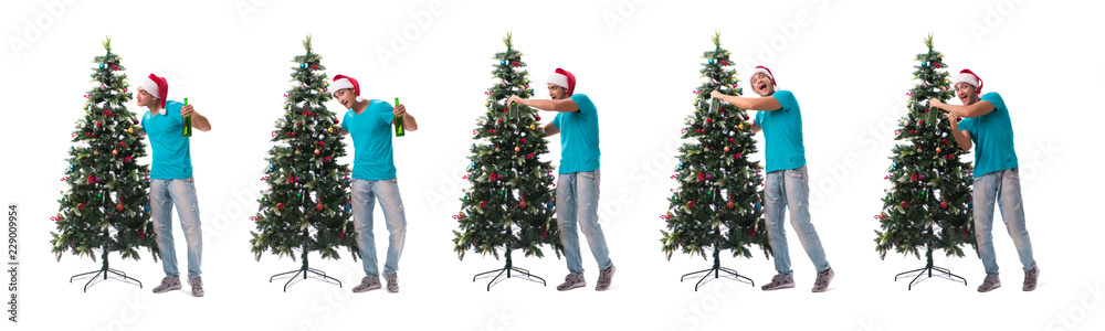 Young man decorating christmas tree isolated on white