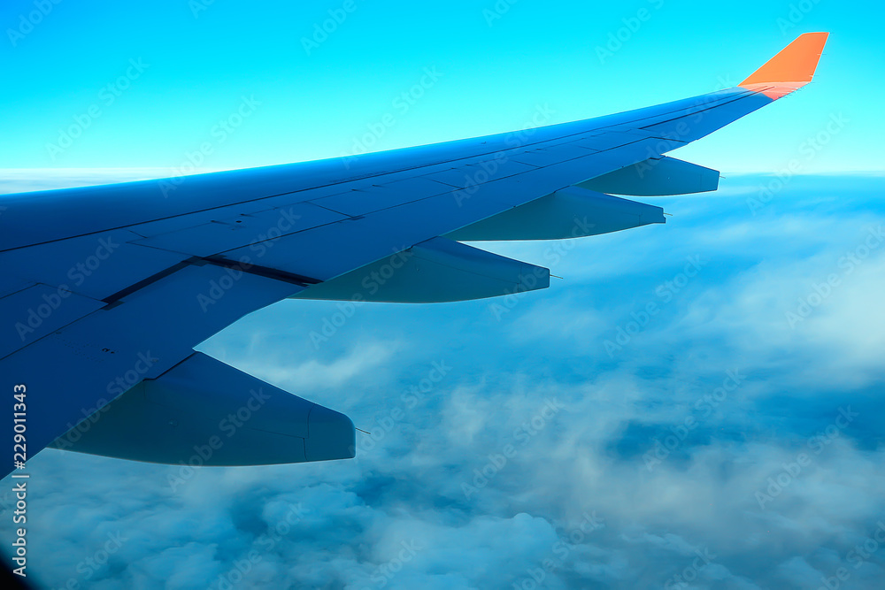 wing airplane view of sky / blue sky and wing of an airplane, view from the cabin of an airplane, concept of air transport wing airplane view of sky / blue sky and wing of an airplane, view from the cabin of an airplane, concept of air transport