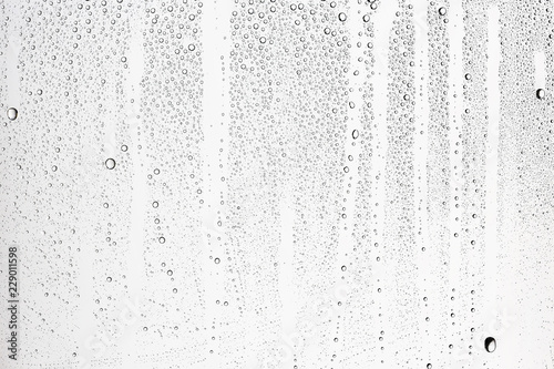 white isolated background water drops on the glass / wet window glass with splashes and drops of water and lime, texture autumn background
