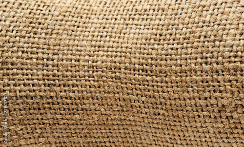 Burlap texture background closeup. tied little ropes