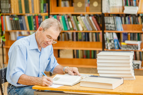 Senior man is preparing for the exam in the library