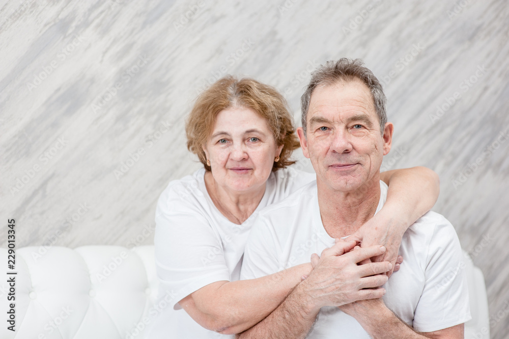 Happy family. Elderly woman hugging her husband. Empty space for text Happy family. Elderly woman hugging her husband. Empty space for text