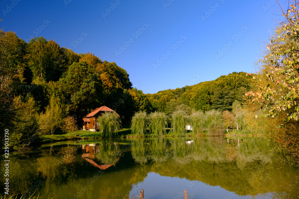 Mountain house over a lake autumn landscape