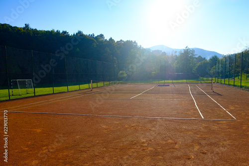 View to tennis court over autumn mountains landscape