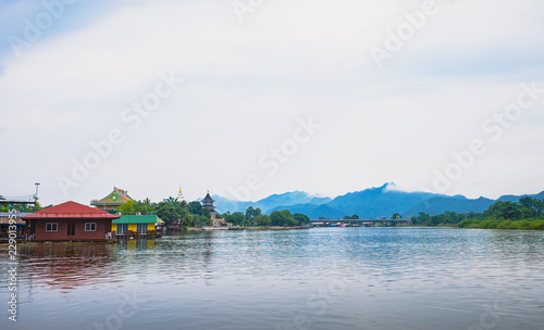 temple and community near the river with mountain background