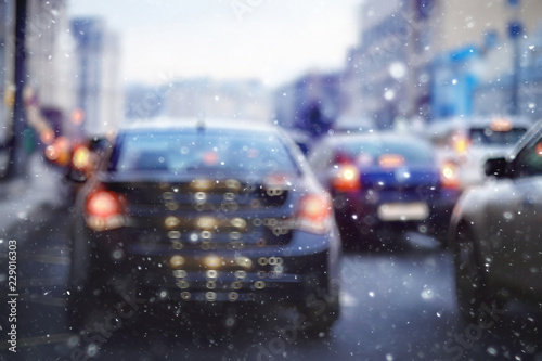 blurred transport background snow / traffic on a winter highway, seasonal auto concept, blurry auto texture, traffic jams © kichigin19