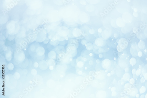 Abstract white bokeh on blue background.