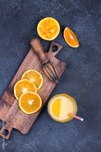 Fresh oranges, grapefruits and madarine slices on dark stone background. photo