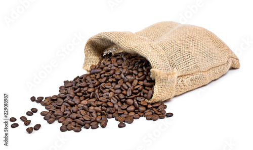 Roasted coffee beans falling out of a burlap sack. Sackcloth bag with coffee beans, isolated on white background.