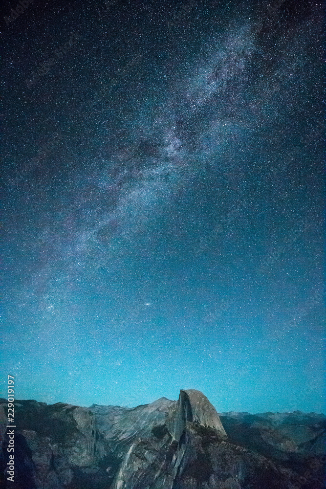 Starry night sky with Milky Way above Half Dome peak, Yosemite National Park, USA