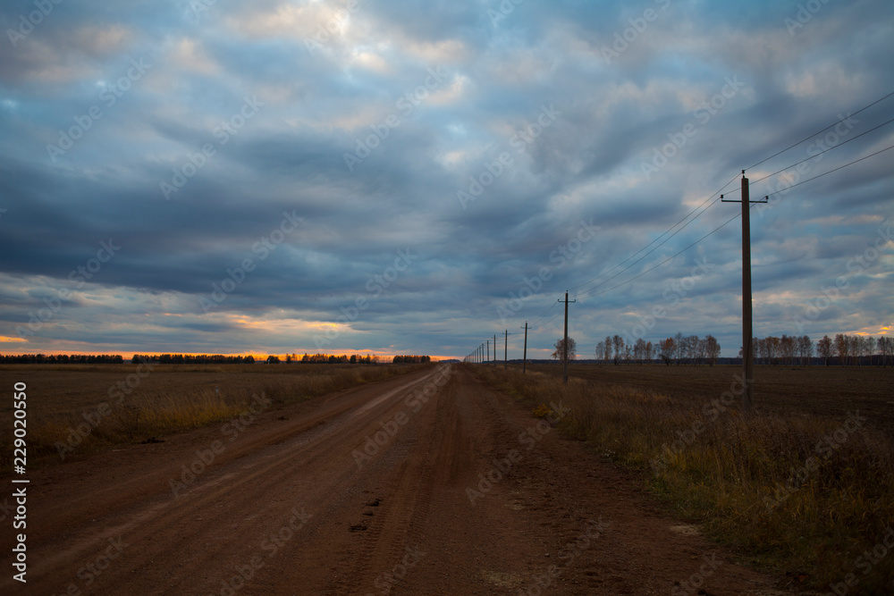 dirt road in the field in the evening