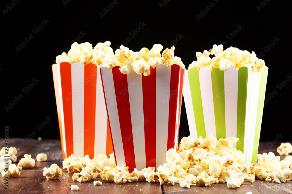 Cinema concept with popcorn in green white bag.