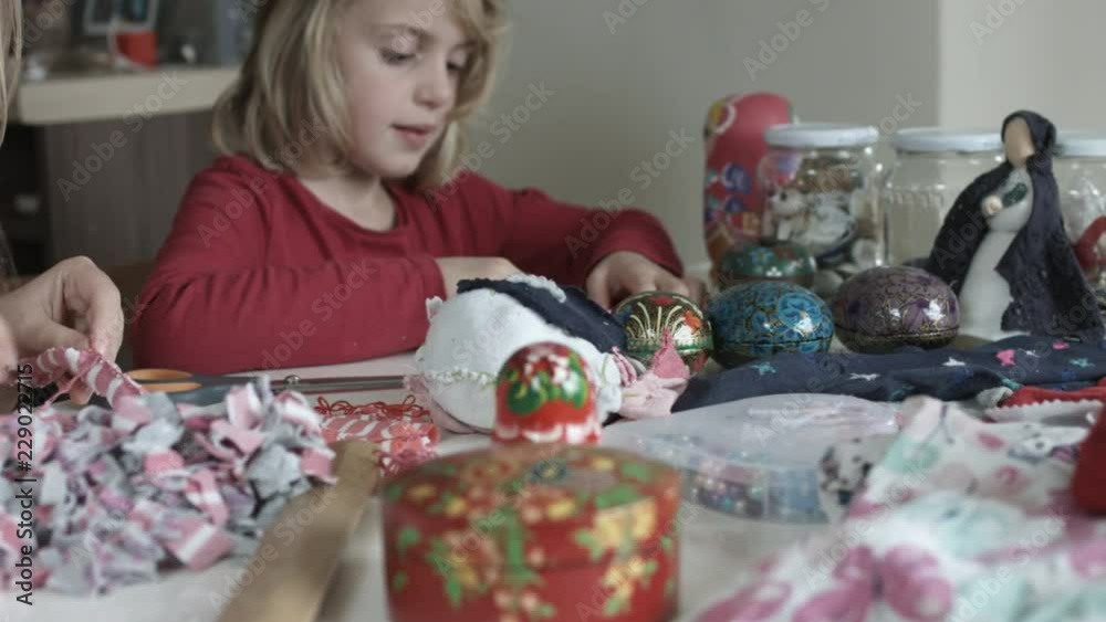 Crafts Table With Mother and Her Daughter In Background Crafts Table With Mother and Her Daughter In Background