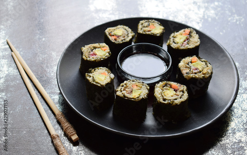 Sushi from cauliflower, avocado, tuna and carrots. Traditional Asian food. Diet healthy food concept. Cereals free. Gluten free. Dairy free. AIP Autoimmune Paleo. Copy space for text.