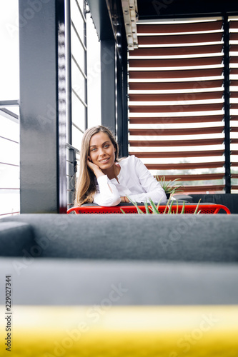Smiling businesswoman sitti...