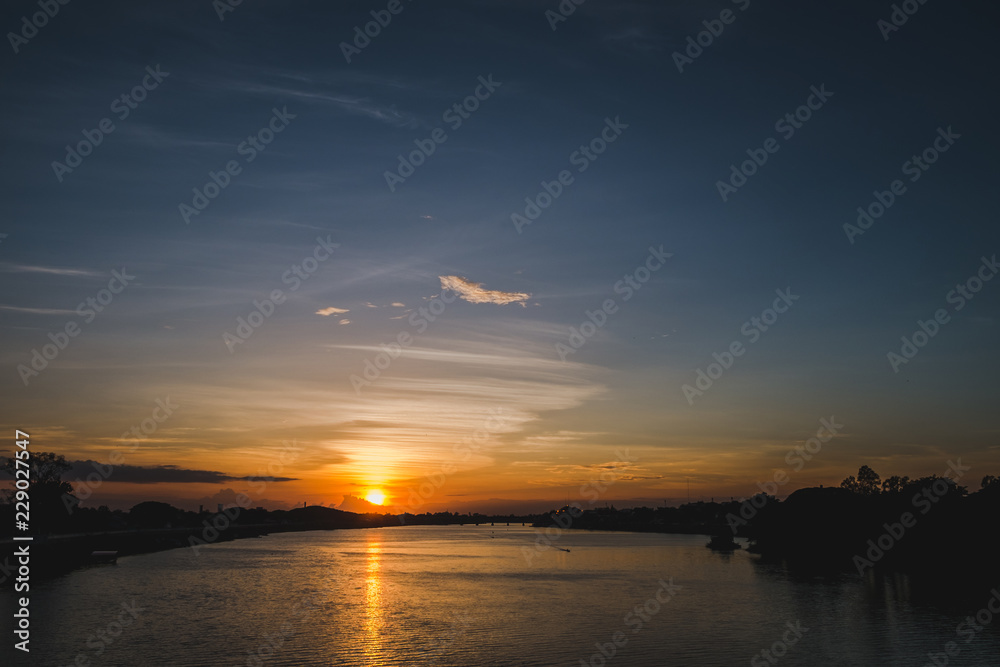 Beautiful sunset reflected in river,Thailand Beautiful sunset reflected in river,Thailand